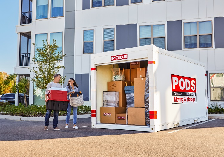 A couple has just begun unloading their ӰPro container, which is positioned in a parking space outside of their new apartment building.