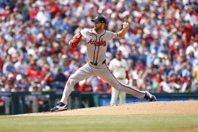 A pitcher for the Atlanta Braves winds up for a pitch during a game.