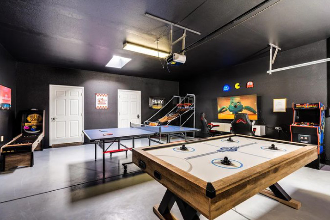  A basement that’s been converted into a game room, with various arcade and table games.