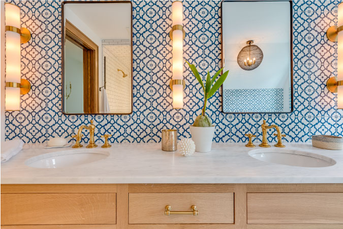 A double vanity with twin rectangular mirrors and eclectic column lighting fixtures