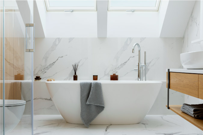  An elegant stand-alone bathtub situated in the middle of a newly remodeled bathroom