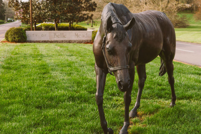 A bronze horse statue adorns a grassy spot at the entrance to Belle Meade, a Nashville suburb