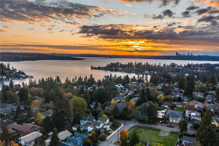 Aerial view of a waterfront community in Bellevue, Washington, at sunset. 