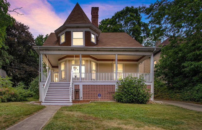 A historical home with bay windows and a large covered porch in Bellevue, Pennsylvania