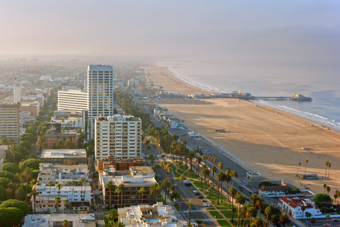 Aerial view of the city of Santa Monica, with its renowned beach and pier, on a sunny morning.