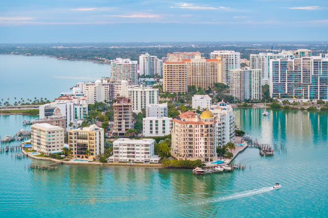 Aerial view of waterfront condos in Sarasota, Florida, on a beautiful sunny day.