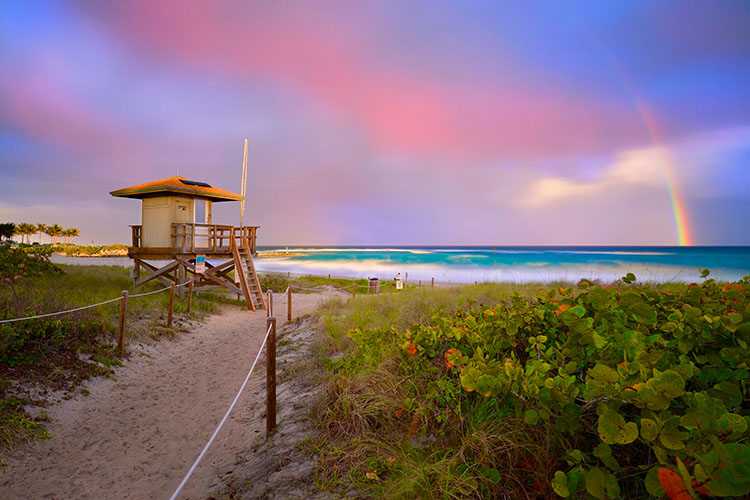 A rainbow hangs over the Atlantic Ocean from a beach in Boca Raton, home to Whisper Walk