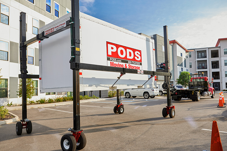 A truck hauls a PODS container on the PODZILLA, loaded with items for someone retiring to Florida.