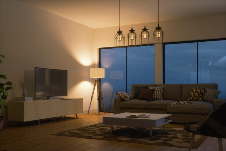 The living room of an apartment is made to appear larger through the use of a tall floor lamp placed in the corner. 