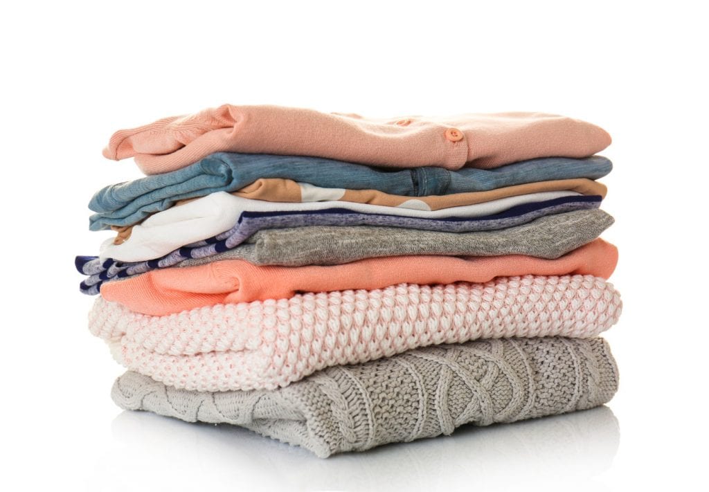 Nicely folded pink, blue, and gray clothes