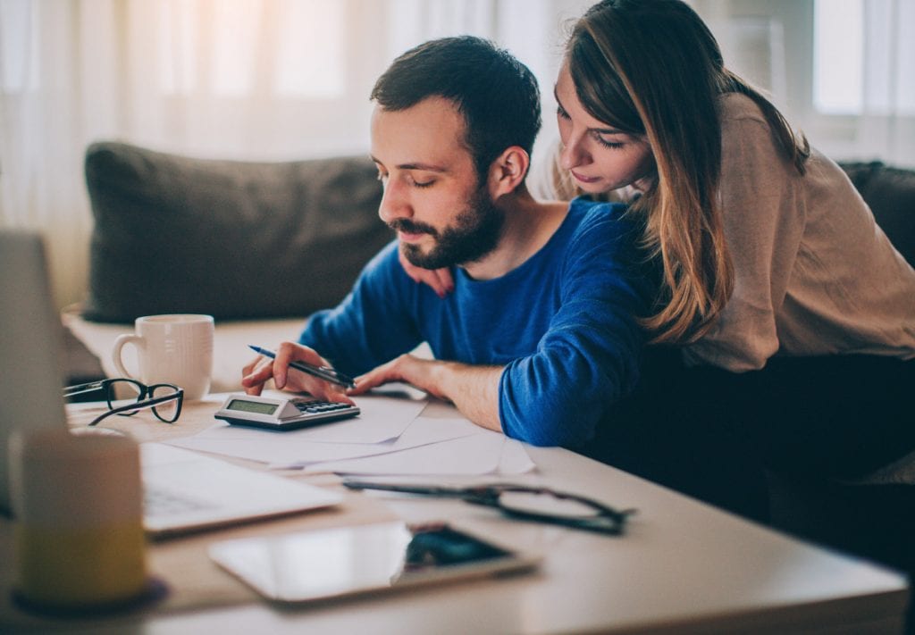 a couple budgeting for their piano move