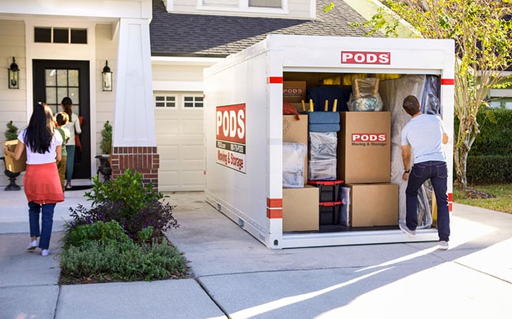 A family loading their 16-foot PODS container, which is about the equivalent of a 10'x15' self storage unit size