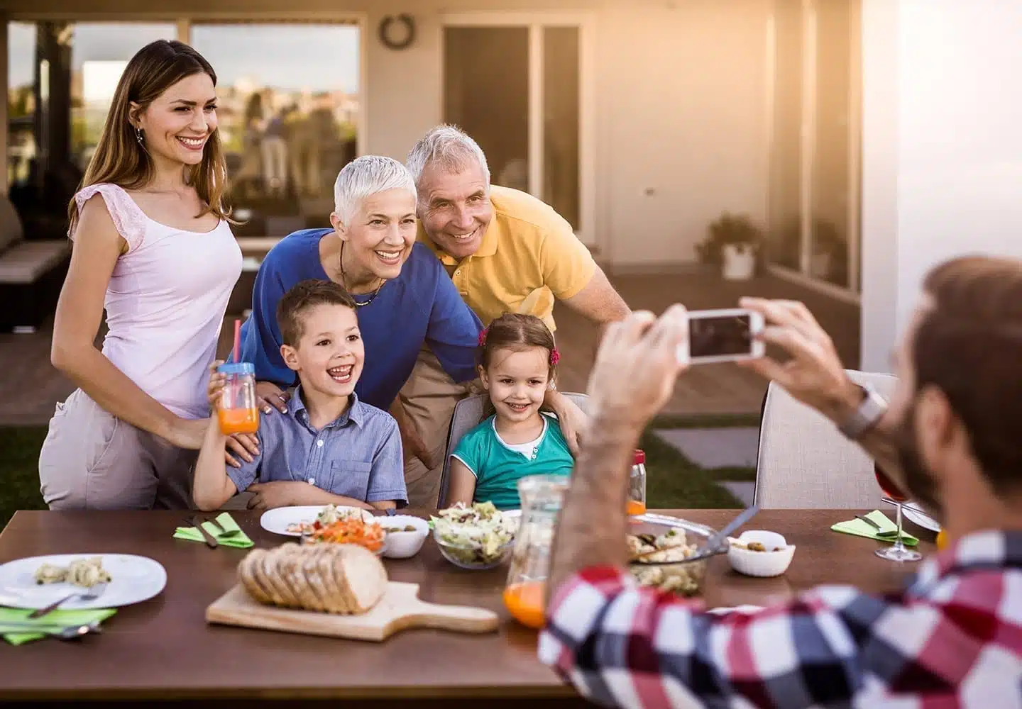 A family poses for a photo in their recently redone outside space
