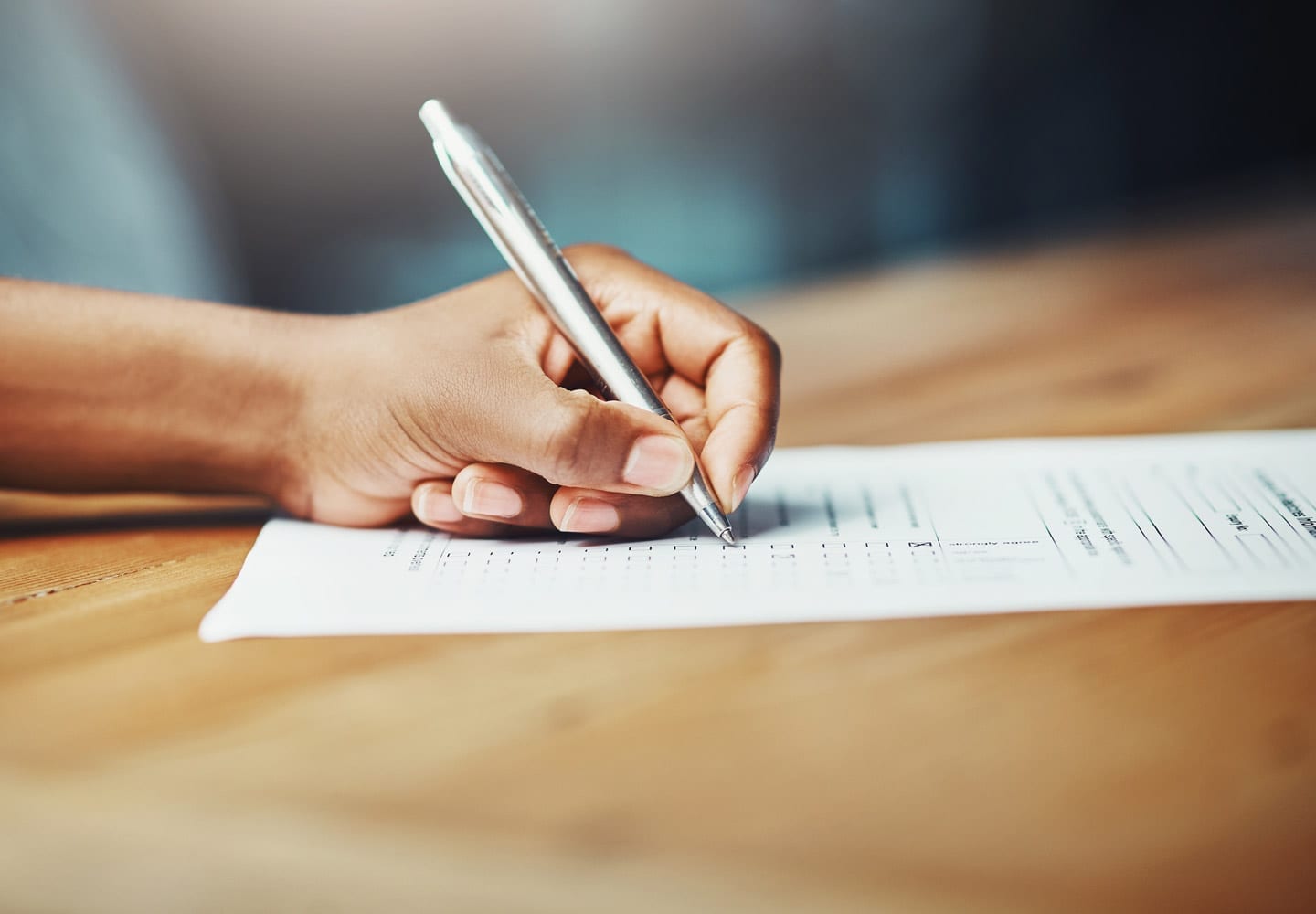 person filling out paperwork while planning their move