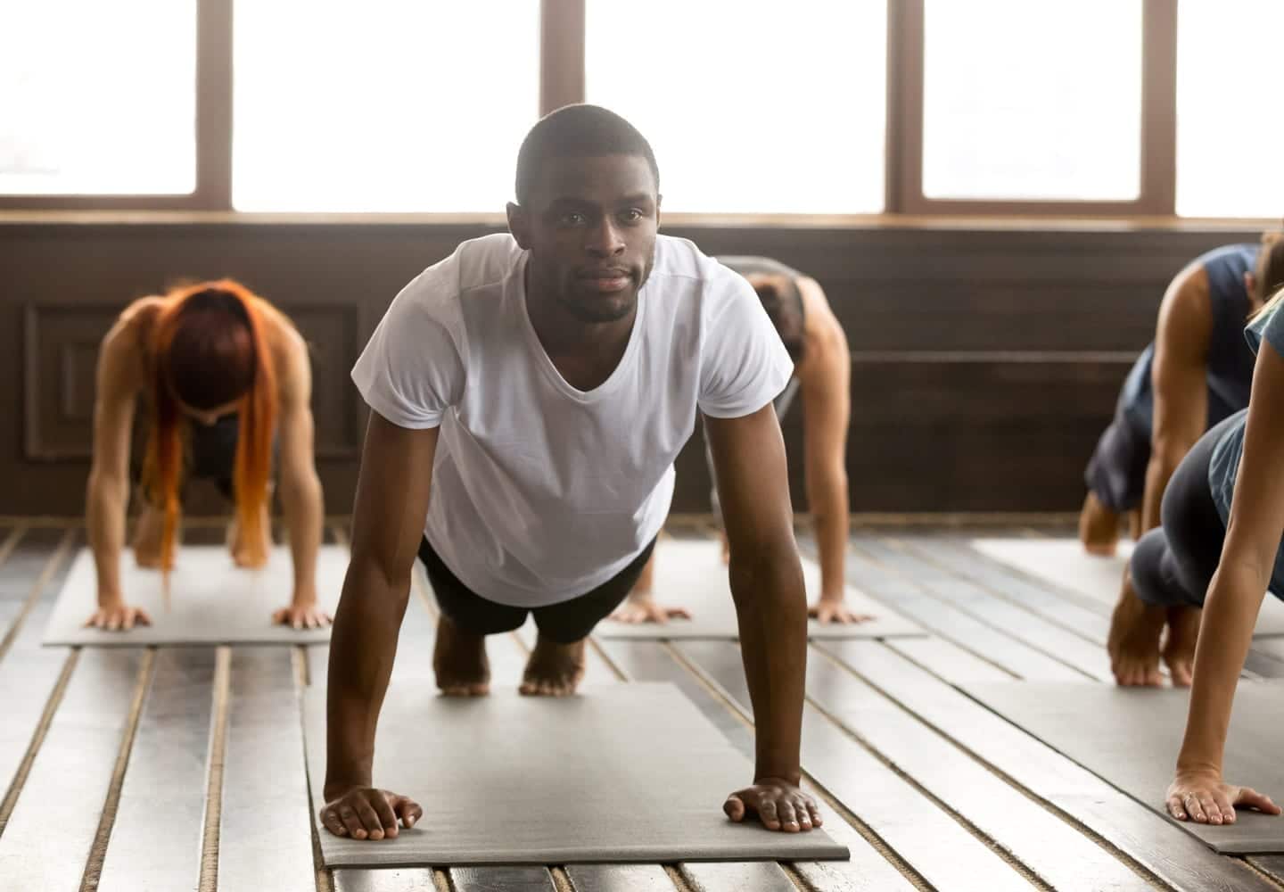 a man doing a yoga pose during a yoga class