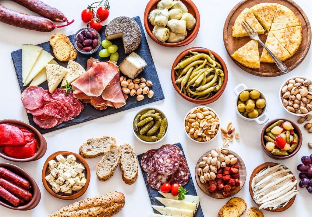 Assorted meats, cheeses, and other food items commonly found on charcuterie boards