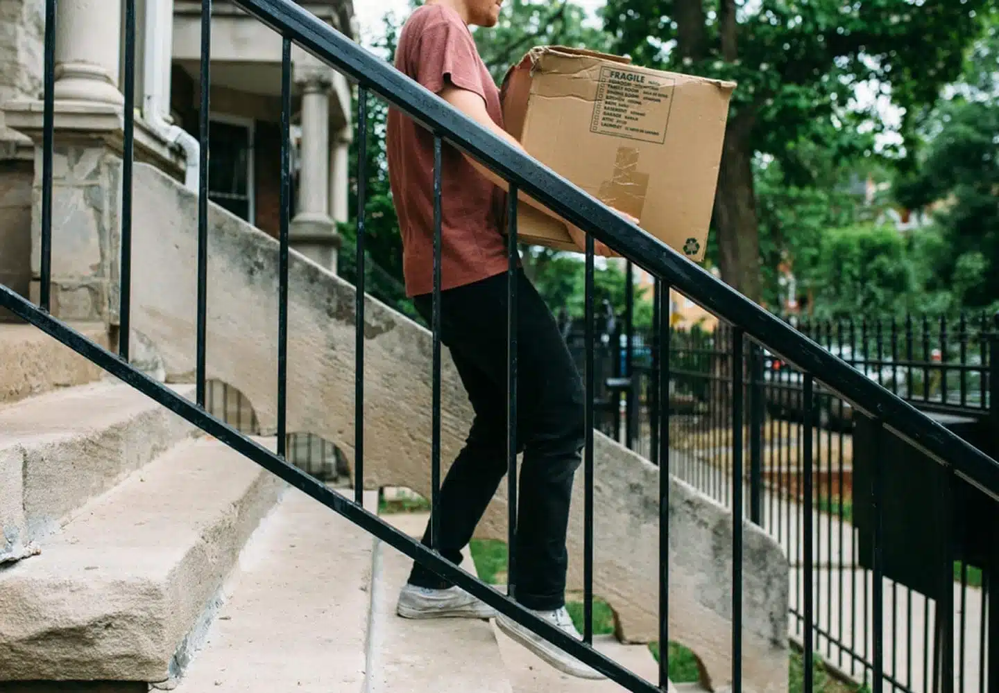 Person carrying box up stairs