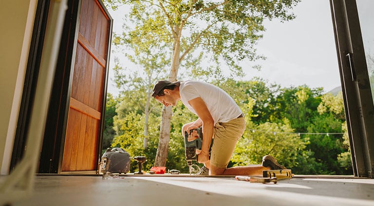 A man nailing down deck boards