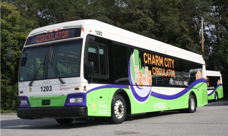 Two Charm City Circulators, Baltimore’s public transit buses, embark on their routes for the day in Baltimore, Maryland.
