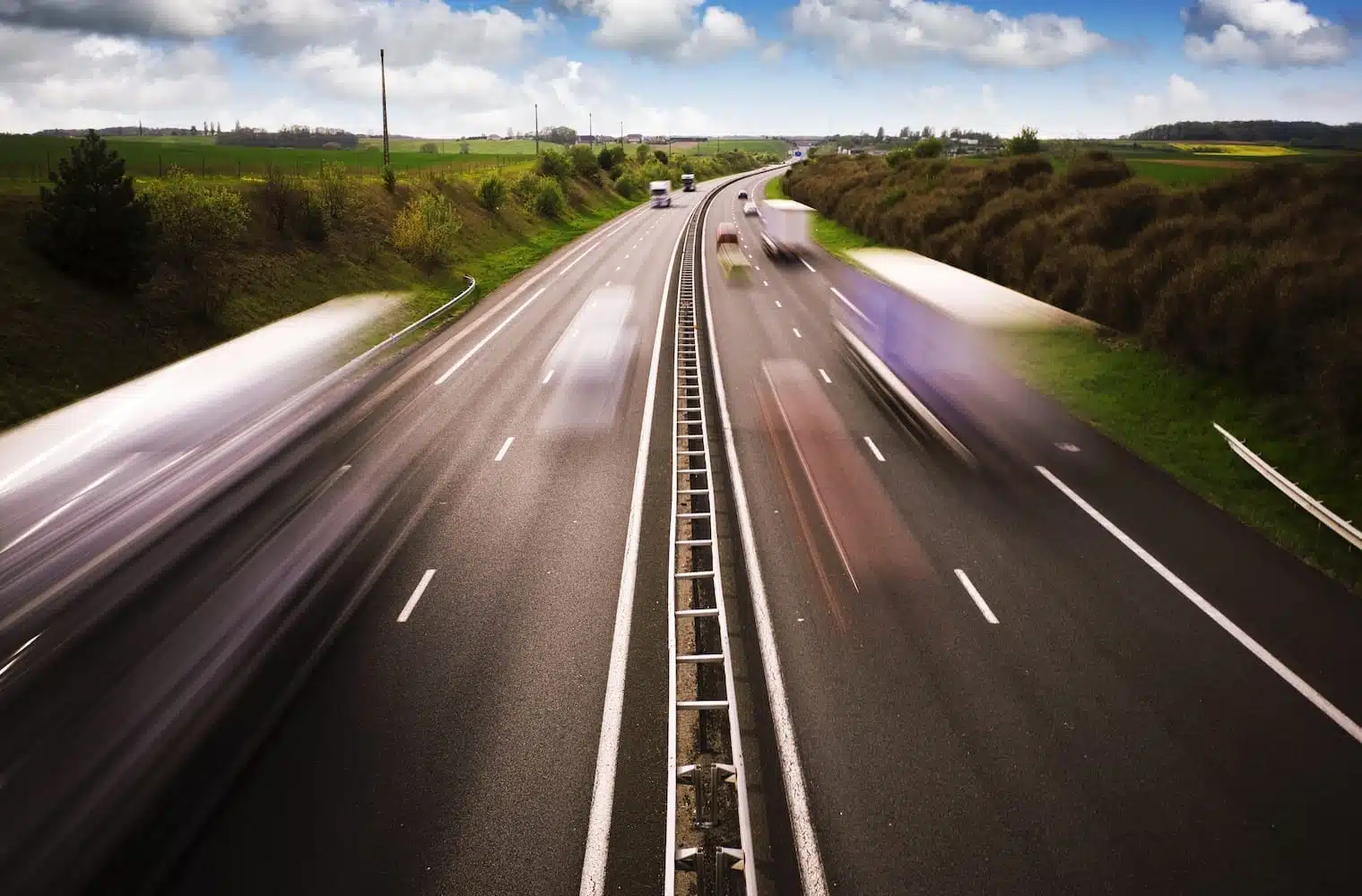 Cars whizzing by on a highway