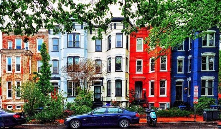 View from across the street of a row of colorful townhomes in Logan Circle — one of the best DC neighborhoods.