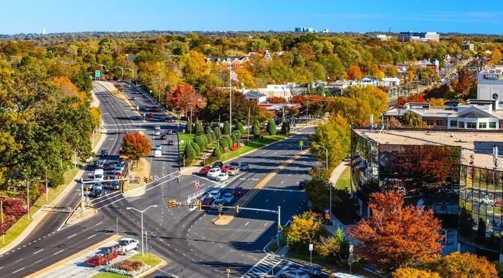 Aerial view of Rockville, Maryland, in the fall. Lush trees that have already begun to change colors with the season fill the spaces between Rockville’s city buildings.