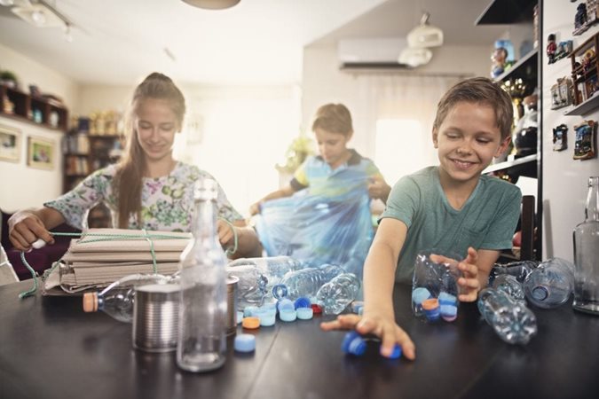 Kids playing and clearing out items they've found during a decluttering session