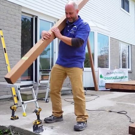 DIY Renovation expert Jeff Thorman carries a piece of lumber for his next project. 