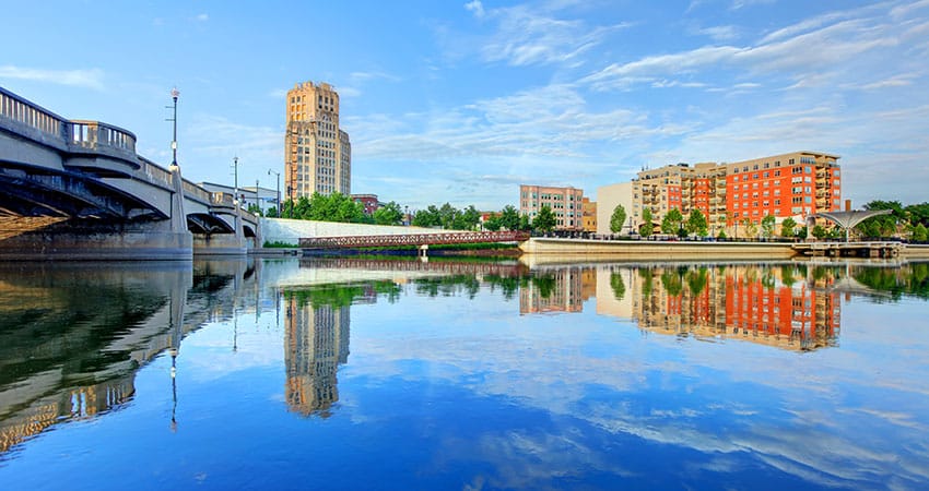 Elgin is a strong city all on its own. This image shows a skyscraper and commercial building standing on the edges of the Fox River on a beautiful summer’s day. 
