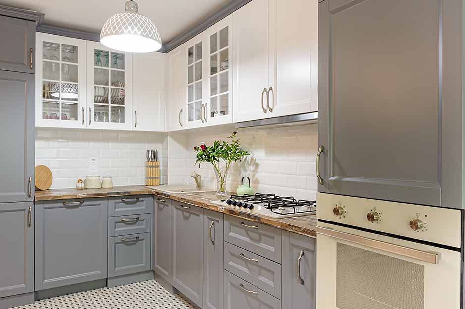 Remodeled kitchen cabinets that have been color blocked vertically