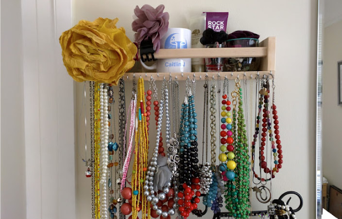An IKEA spice rack, repurposed as a necklace organizer.