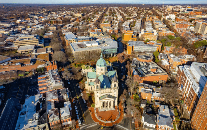 An aerial view of the Fan District and the Virginia Commonwealth University in Richmond, Virginia. The Cathedral of the Sacred Heart stands impressively in the center of the image with its grand columned entrance.