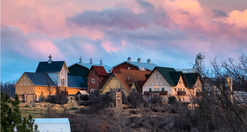 The sun is beginning to set as pastel-colored clouds float above the New Glarus Brewing Company in New Glarus, Wisconsin.