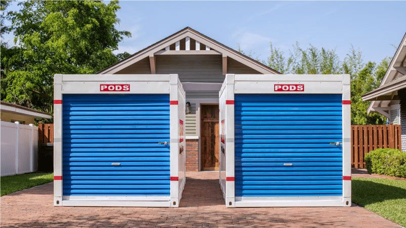 Two PODS portable moving containers are positioned in a residential driveway, ready to be loaded with furniture and boxes for a family’s move.