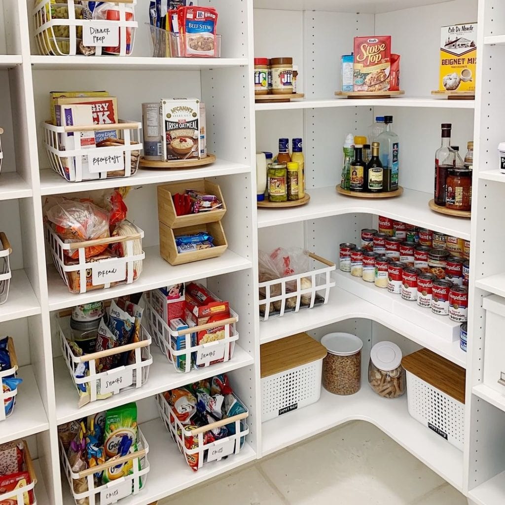  An organized pantry that utilizes boxes, bins, containers, stacking shelves, and lazy Susans