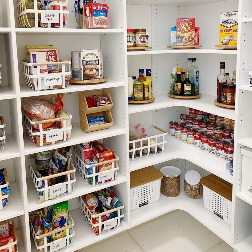 An organized pantry that utilizes boxes, bins, containers, stacking shelves, and lazy Susans