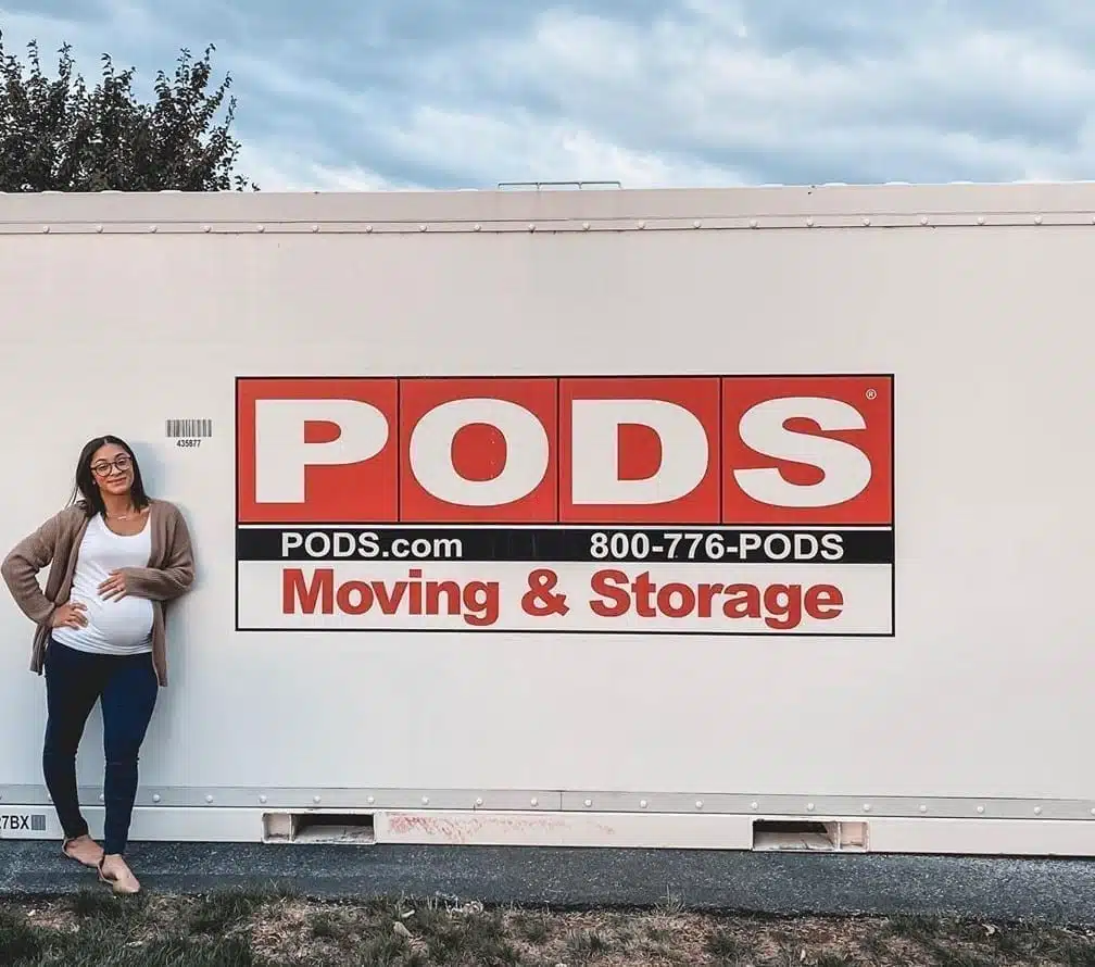 pregnant woman in front of PODS container