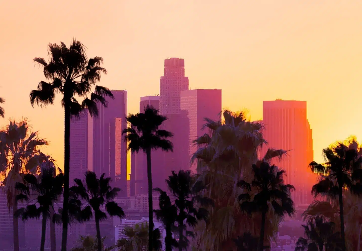 Downtown Los Angeles at sunset. The sun is coloring the buildings in the shade purple