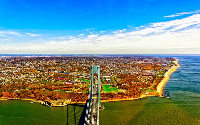 An aerial view of Verrazano Narrows Bridge leading to Staten Island, New York, on an autumn day. 