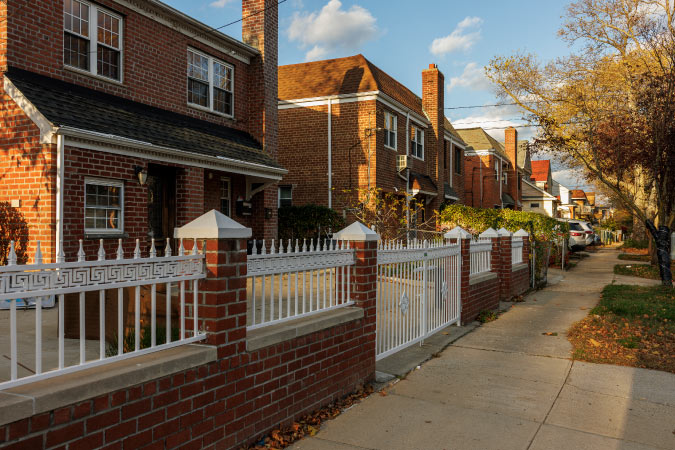 A row of brick homes in Flushing, Queens, during an afternoon in autumn.