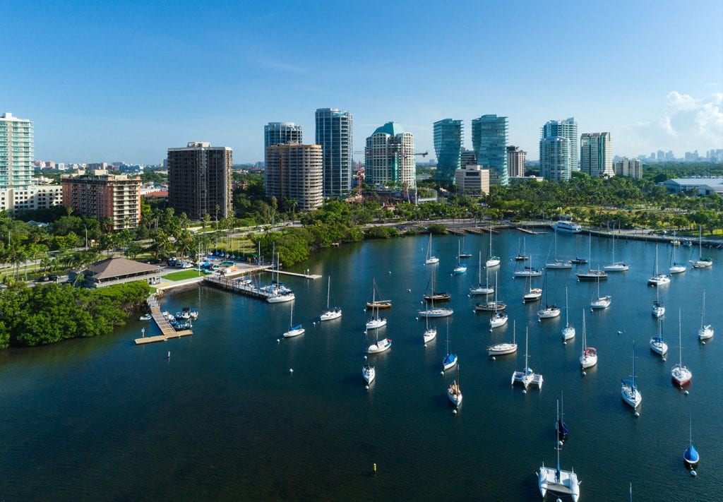 Boats are anchored in the water beside the Coconut Grove neighborhood in Miami.