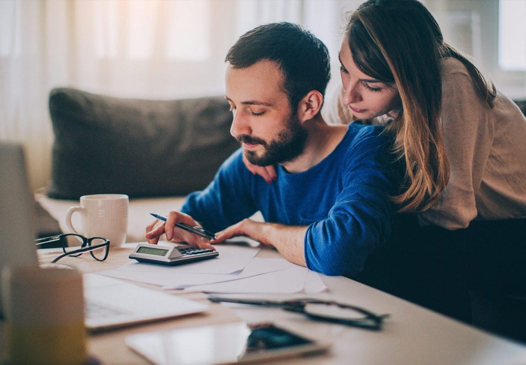 A couple works together to settle their budget before applying to rent an apartment in Miami.