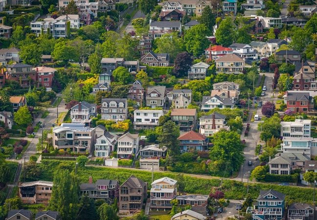 Aerial view of large, multi-story residential buildings on a hill in Queen Anne, one of the most recognizable Seattle neighborhoods.