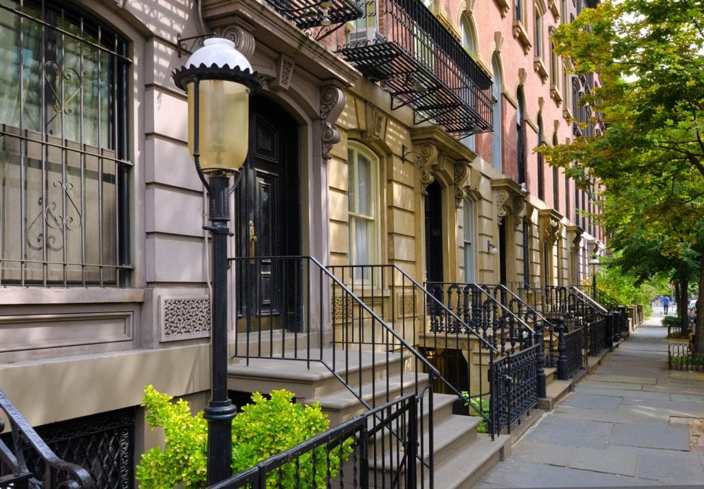 A view of some of the brownstone facades  lining one of the streets in the East Village of Manhattan.