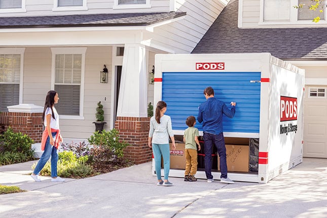 A family closes their PODS container after using professional moving hacks to expedite their move.