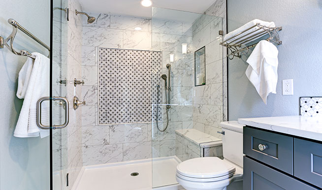 A shower with a detailed back wall. In the center of the wall, there is a square with a diamond pattern.
