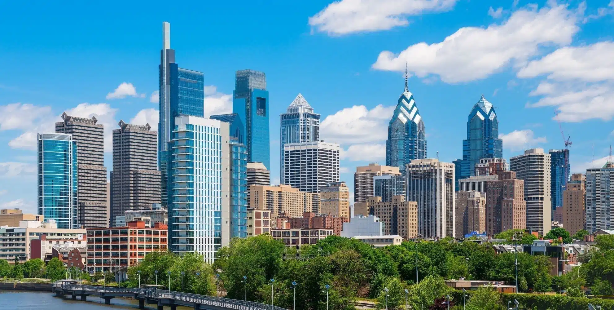 The Philadelphia skyline on a sunny day, as seen from across the water.