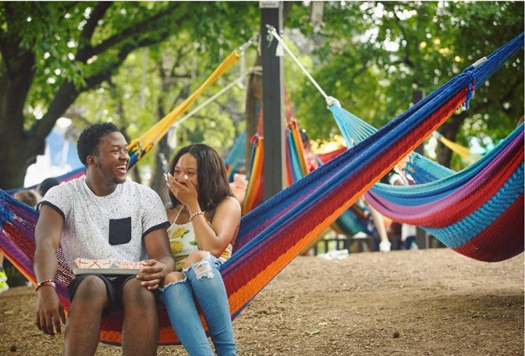A couple shares a laugh as they relax on a hammock in Spruce Street Harbor Park in Philadelphia’s Society Hill neighborhood.