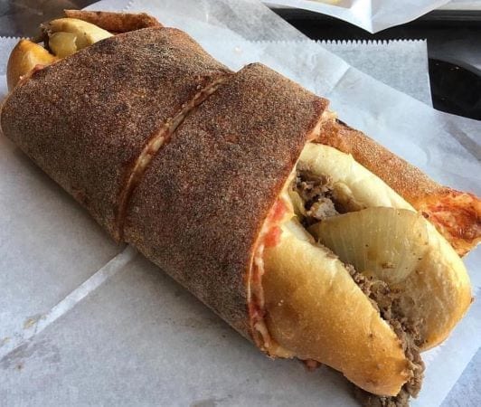 A Philly Taco from Jim's Steaks in Philadelphia. It's a Philly cheesesteak wrapped inside a slice of pizza.