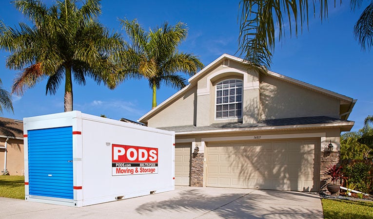 A PODS portable moving and storage container in the driveway of a home in Sarasota, Florida